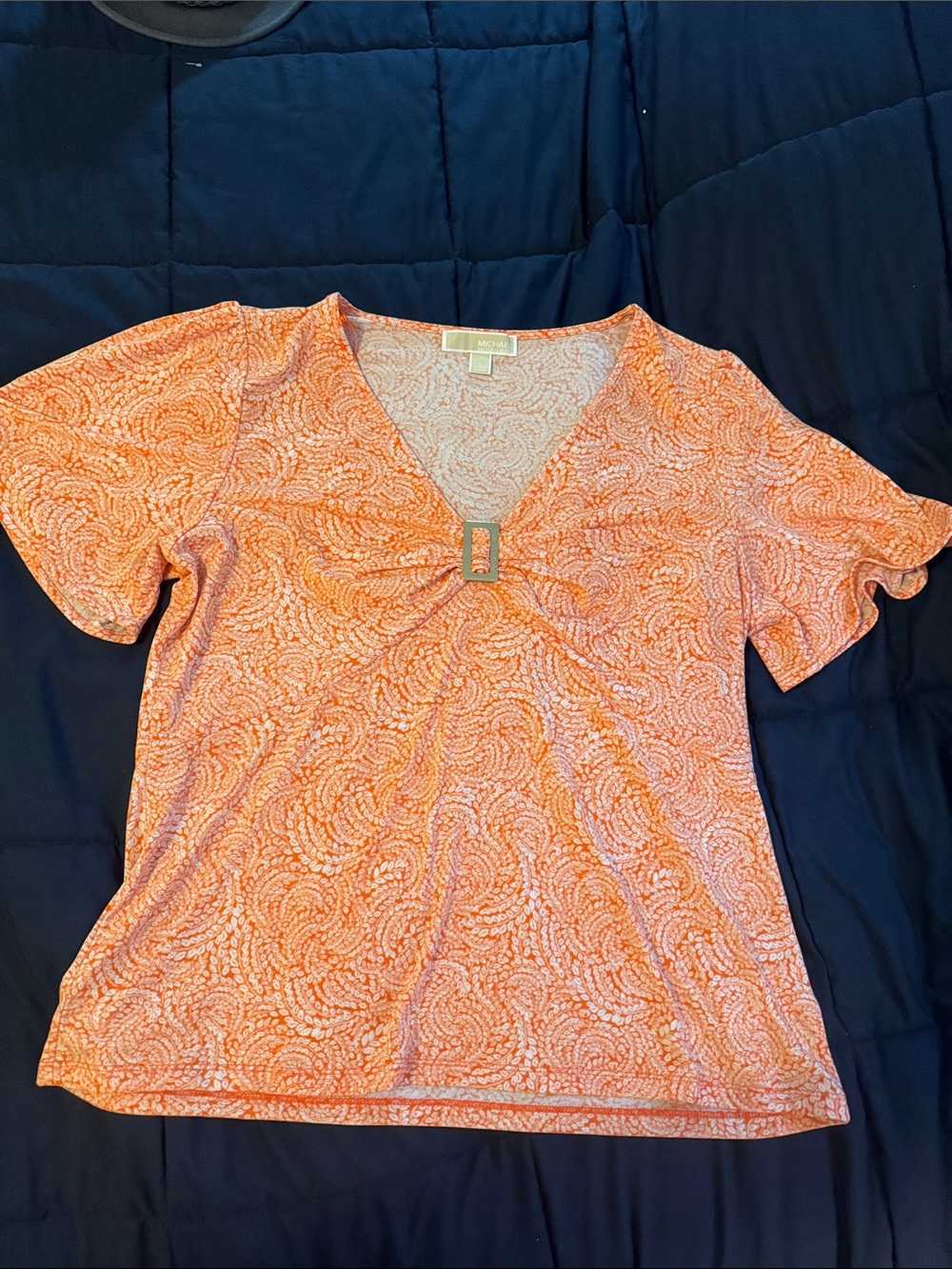 Michael Kors Orange Swirl V‑Neck Short Sleeve Top with Decorative Buckle